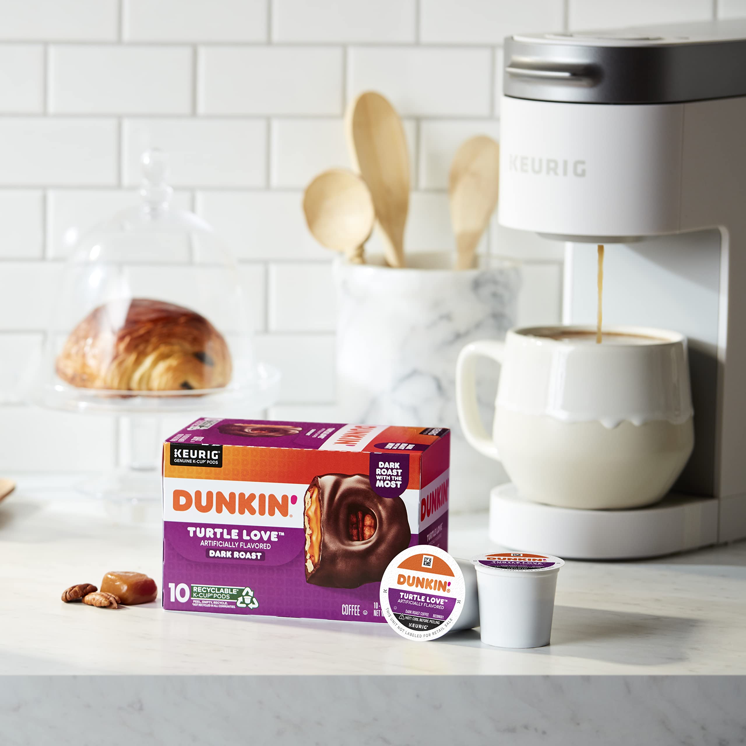 Dunkin' pod next to standard mug showing single-serve size benefit