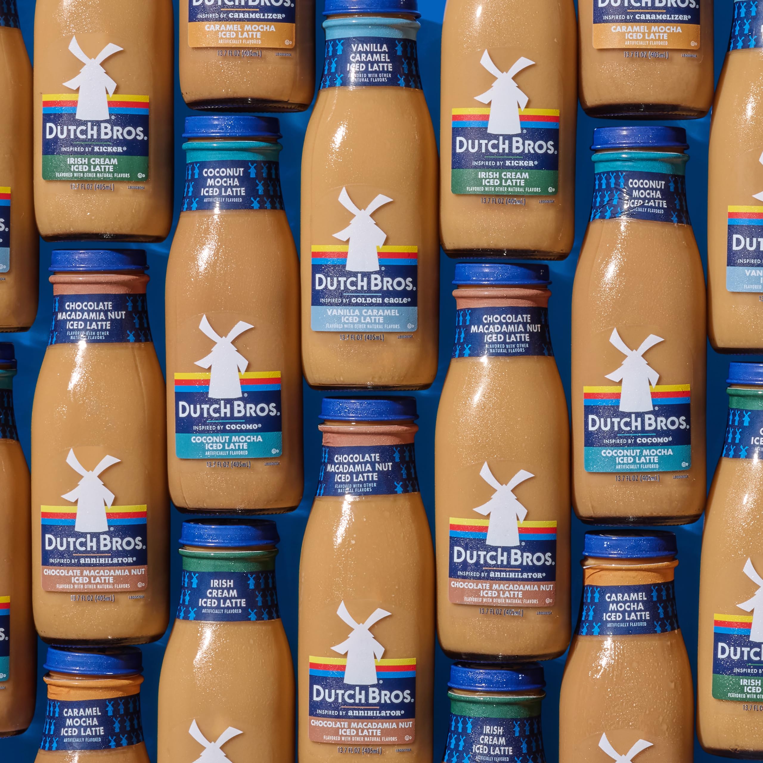 Dutch Bros bottle held in hand for scale, showing 13.7 fl oz single-serve portability