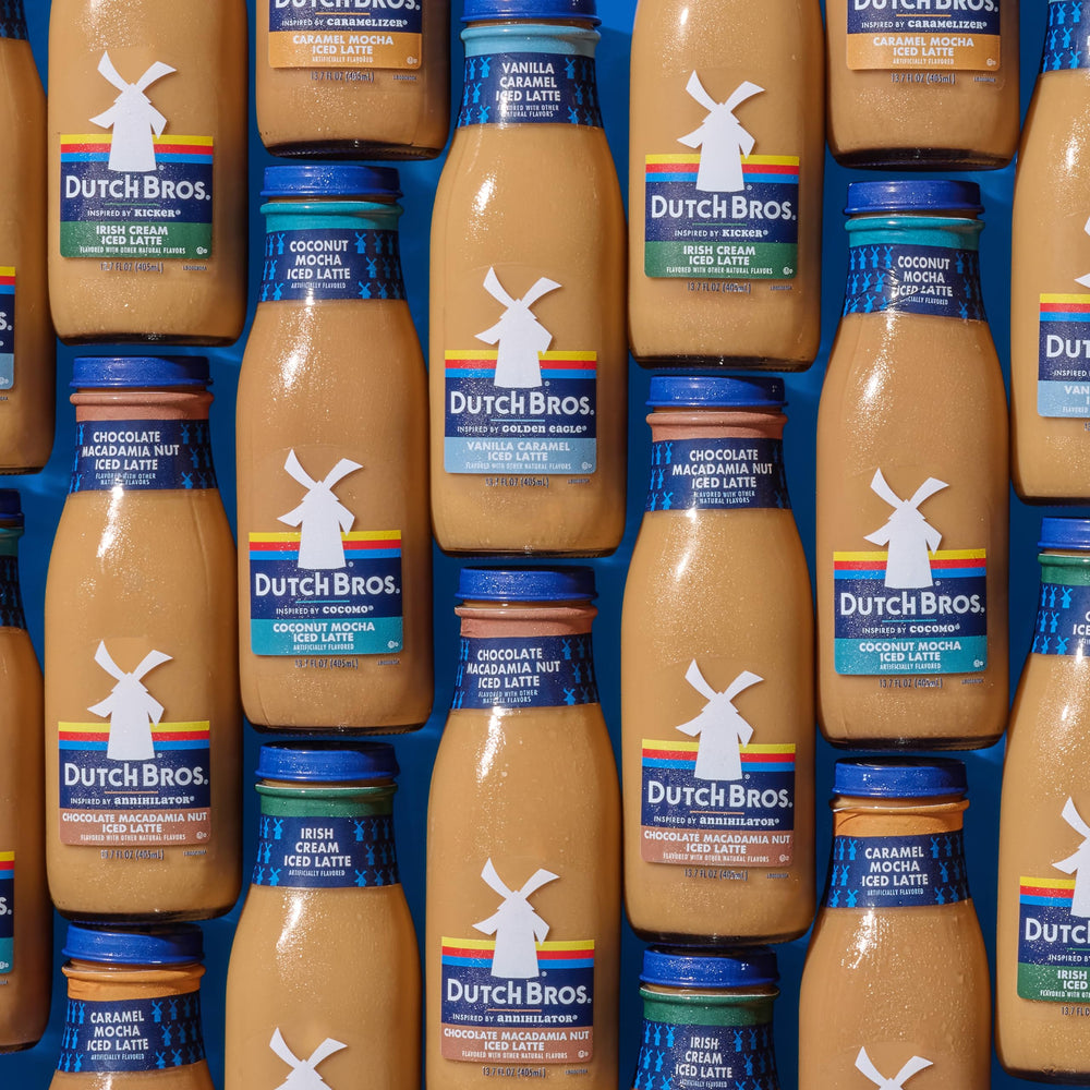 Dutch Bros bottle held in hand for scale, showing 13.7 fl oz single-serve portability