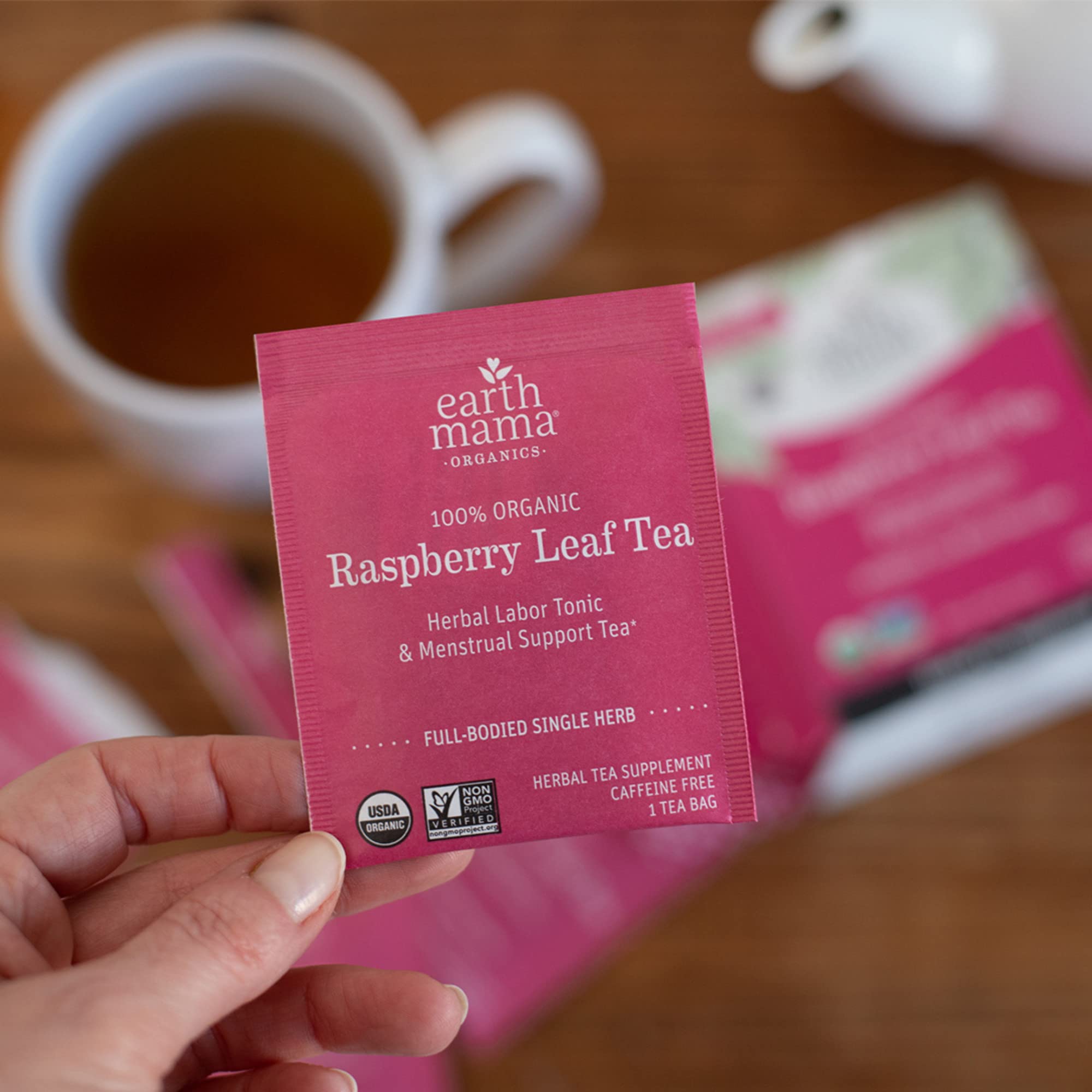 Earth Mama tea bag beside measuring cup showing serving size guidance