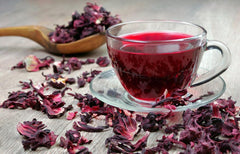 EarthWise Aromatics brewed hibiscus tea in a pitcher illustrating vibrant color and serving suggestion