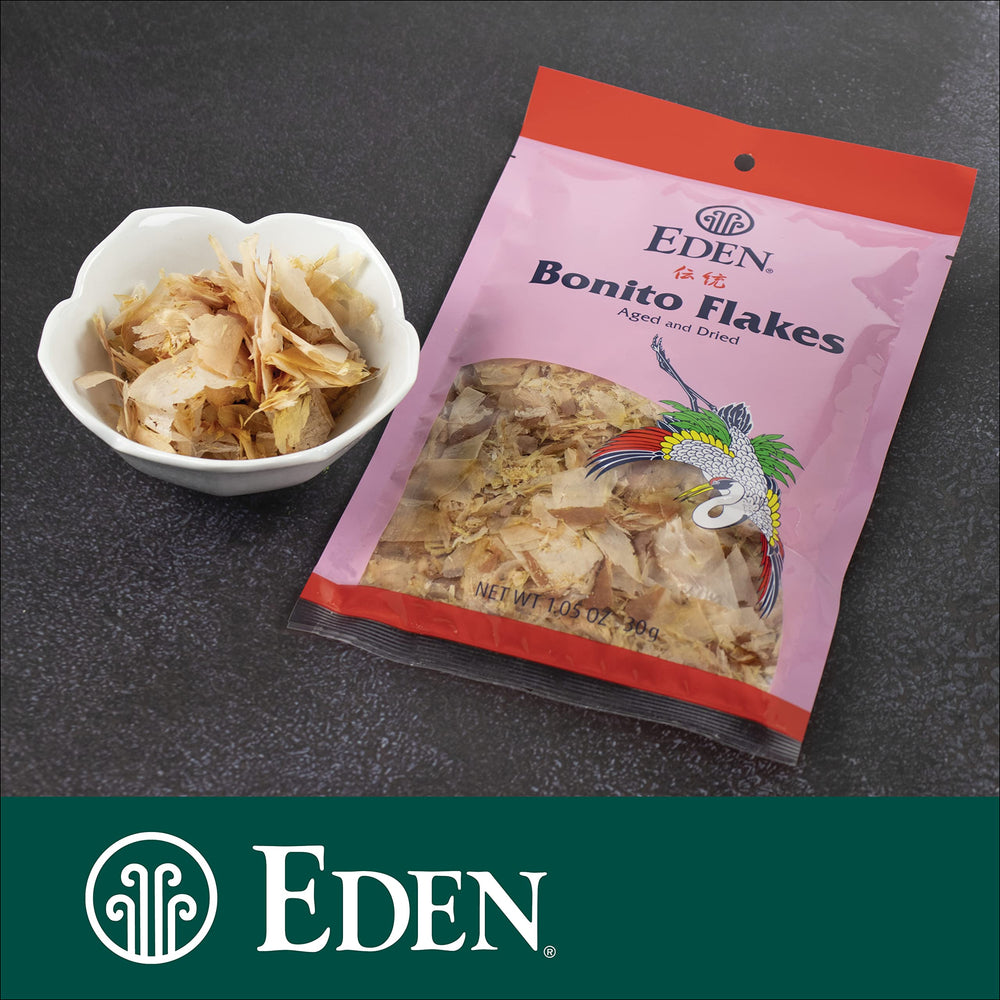 CREATION AND MAINTENANCE OF PURITY IN FOOD flakes steeping in sauce to infuse smoky umami