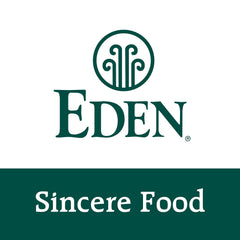 Eden Organic Sauerkraut 18 oz glass jar next to utensils for size reference and pantry convenience