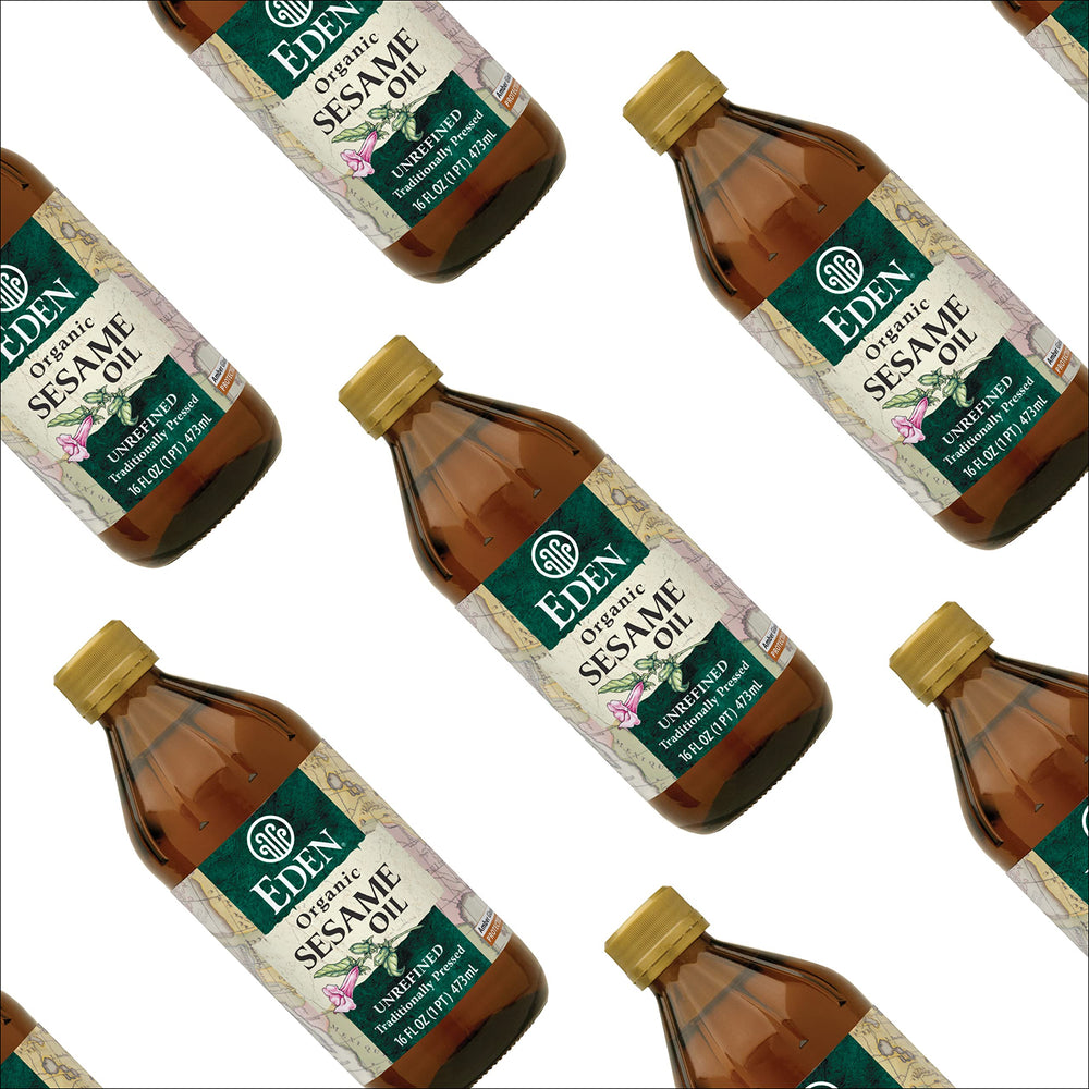 Eden Organic beside tablespoon for scale showing 16 fl oz bottle sizing