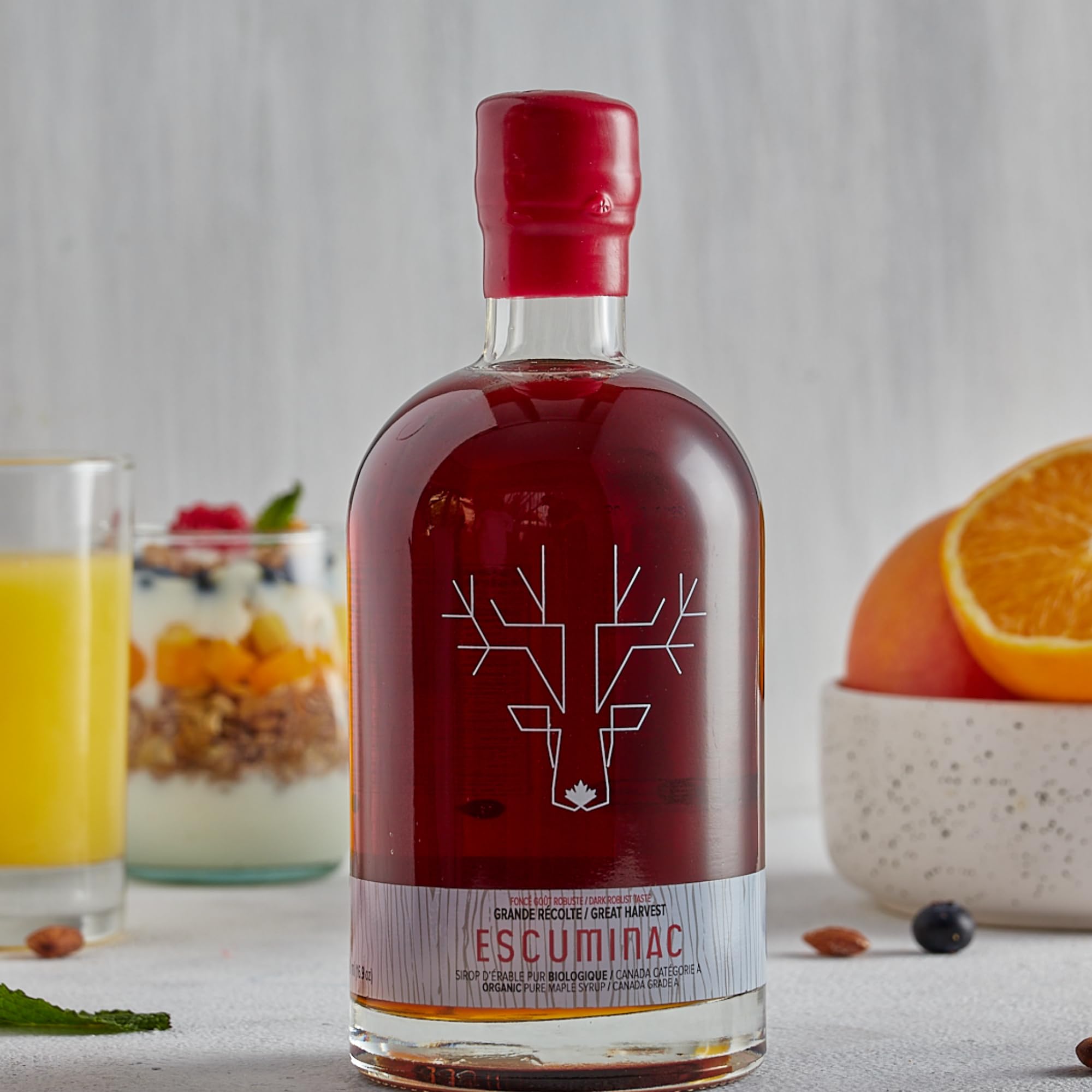 Escuminac pouring syrup over pancakes showcasing serving inspiration