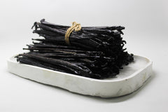 ESSENCE FOOD & BEVERAGE vanilla beans steeping in a glass jar of alcohol, rich extract ready