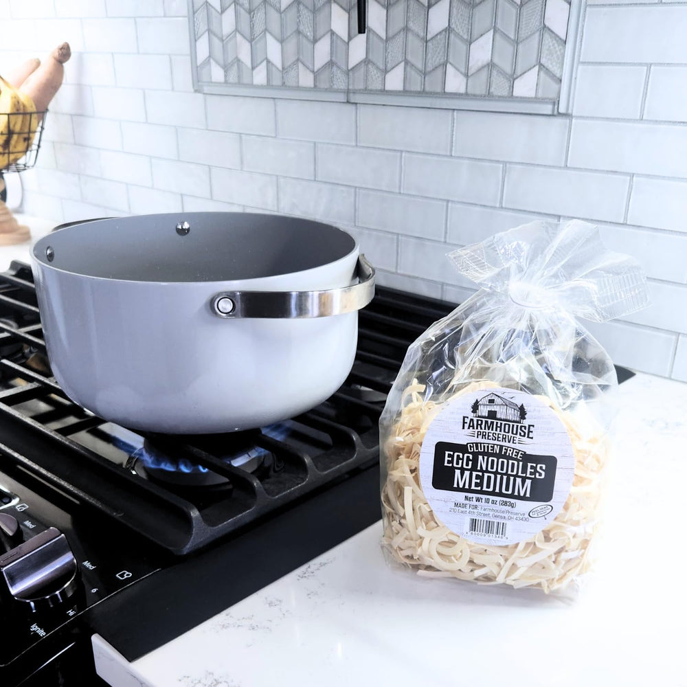 Dry Farmhouse Preserve noodle pile next to a measuring cup showing portion size