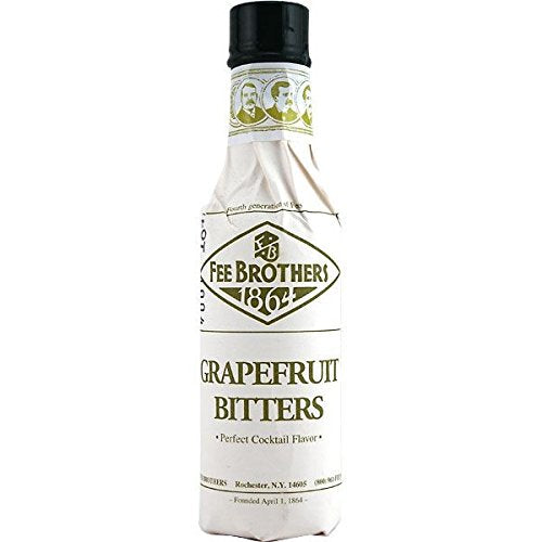 Fee Brothers bitters being dashed into a cocktail with grapefruit garnish, enhances balance