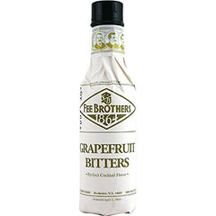 Fee Brothers bitters being dashed into a cocktail with grapefruit garnish, enhances balance
