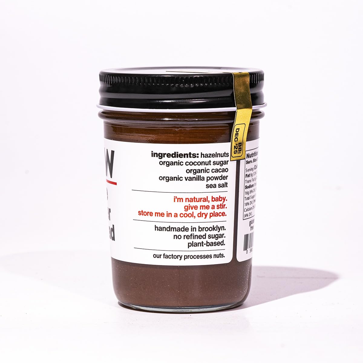 Fine & Raw opened jar with spoon highlighting creamy spreadable texture and richness