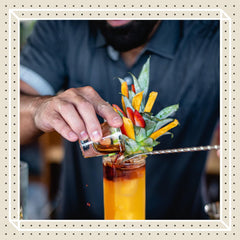 Finest Call bottle held in hand to show scale and easy handling for busy bars