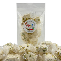 FirstChoiceCandy single unwrapped pistachio nougat piece revealing nut distribution and bite appeal
