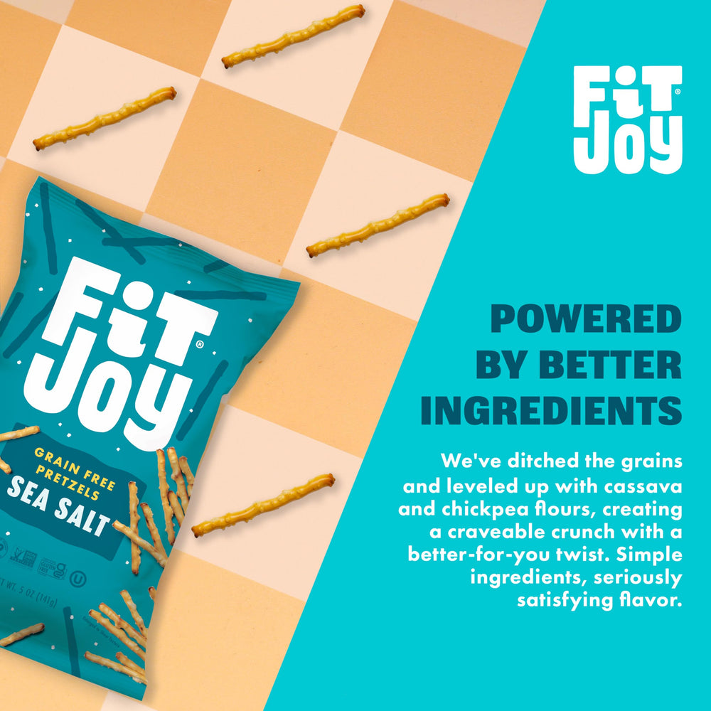 FitJoy pretzel stick dipping into hummus showing scoopable shape and utility