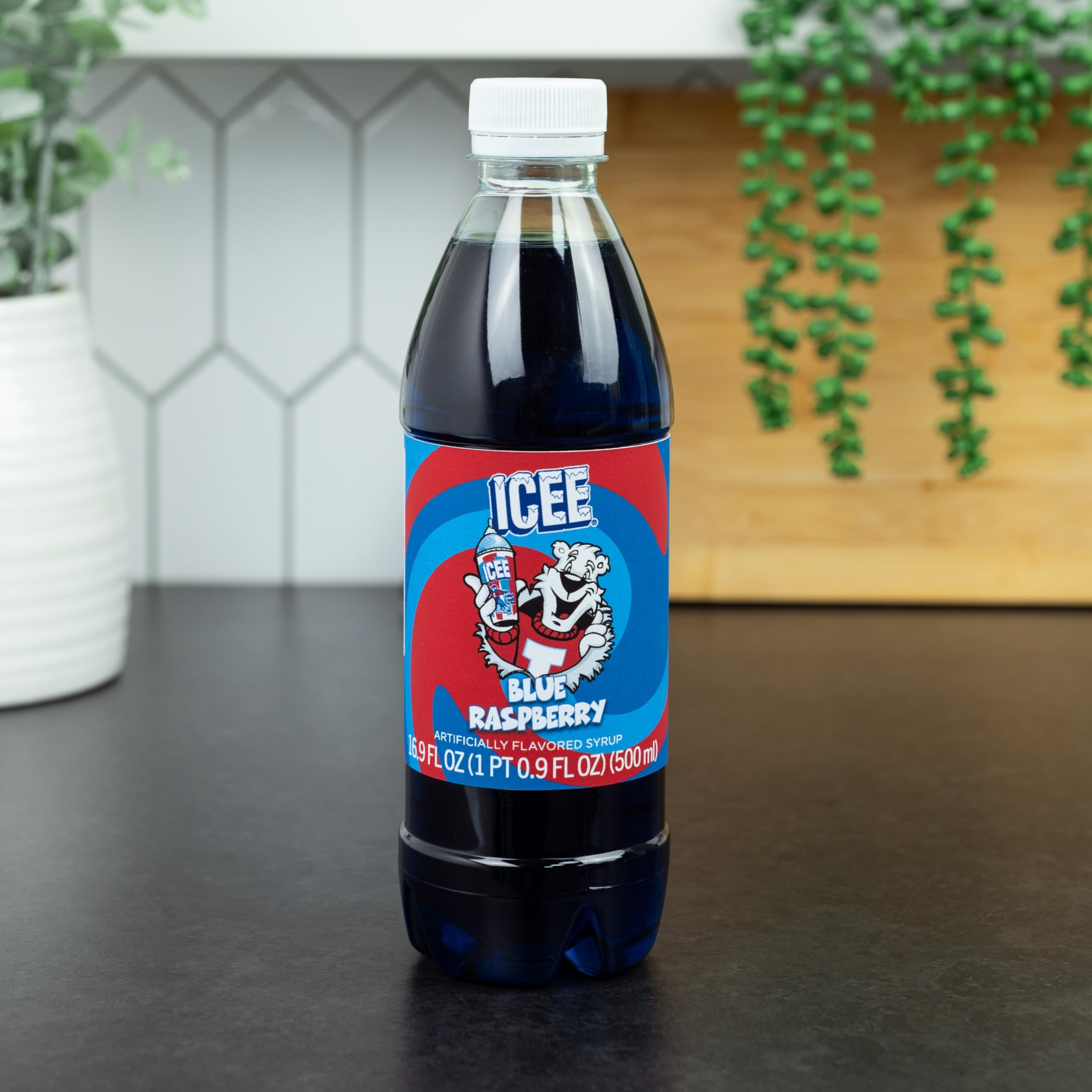 Fizz Creations ICEE blue raspberry syrup being poured into a slushie cup, creating vibrant color