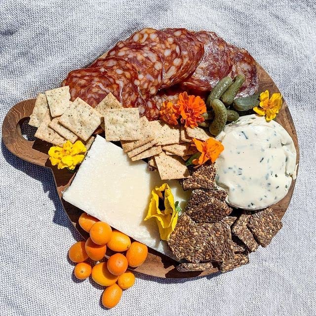 Cheese and vegetables with Flackers on a snack board showing flavorful entertaining benefit