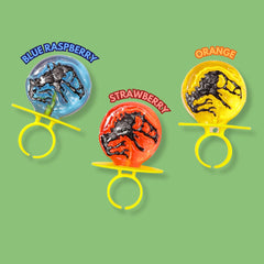 Flix Candy close-up of dinosaur ring detail showing molded dino topper and bright color for kid appeal