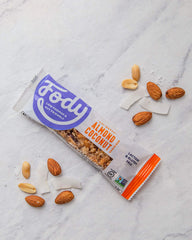 Fody bar bite cross-section revealing crisp brown rice and nut pieces for satisfying texture
