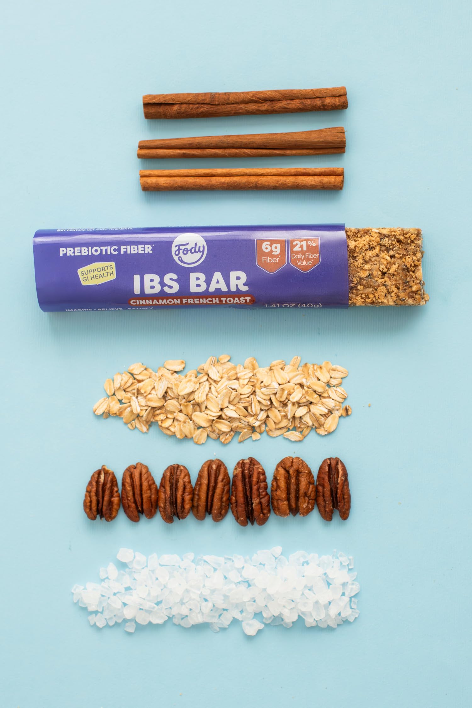 Maple syrup and pecans near Fody bar ingredients showcasing natural sweetness and nutty crunch