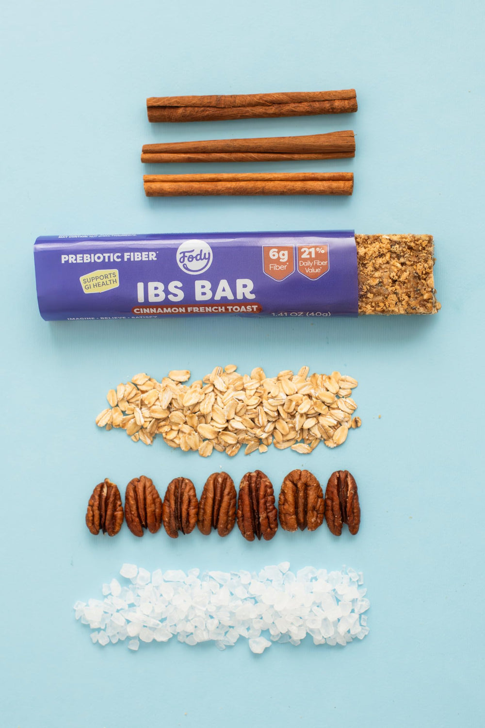 Maple syrup and pecans near Fody bar ingredients showcasing natural sweetness and nutty crunch