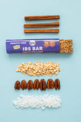 Maple syrup and pecans near Fody bar ingredients showcasing natural sweetness and nutty crunch