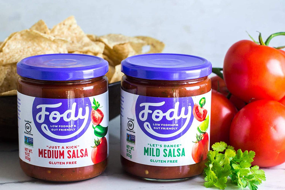 Fody mild salsa jar in hand showing 16 oz size and pantry friendly