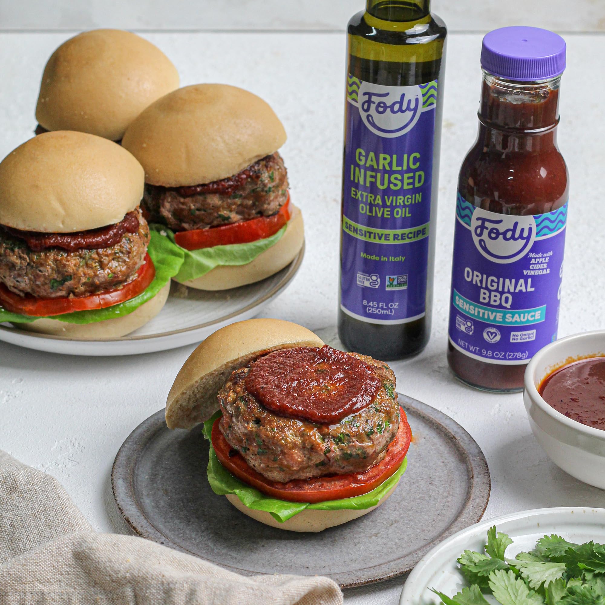 Fody sauce served on burger in kitchen setting showing versatile, IBS-friendly condiment