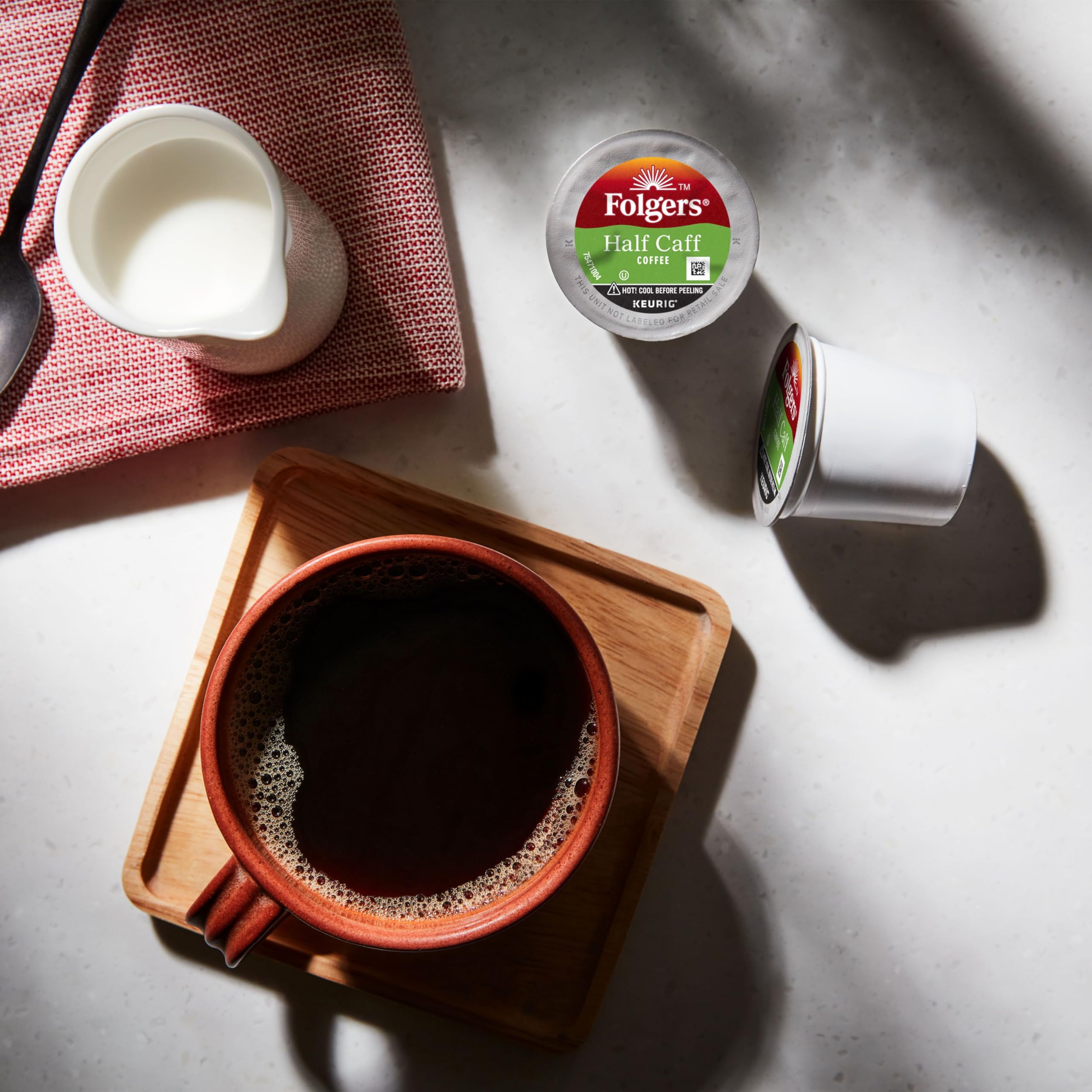 Pouring brewed Folgers coffee from Keurig showing smooth medium roast