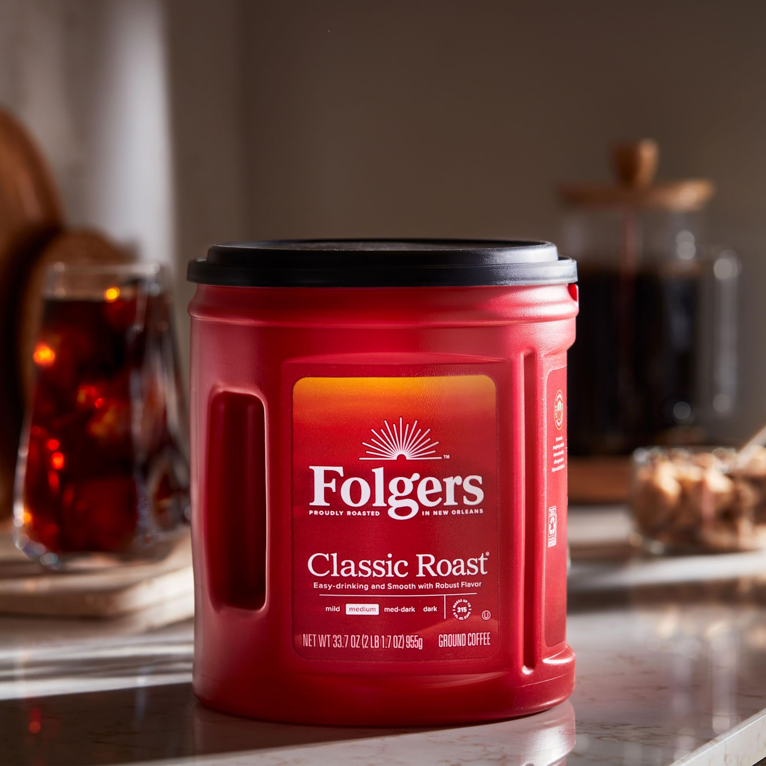Folgers open canister with spoon showing scoopable grounds for convenient measuring