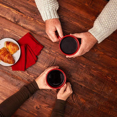 Folgers Half Caff brewed cup beside canister showing comforting morning benefit