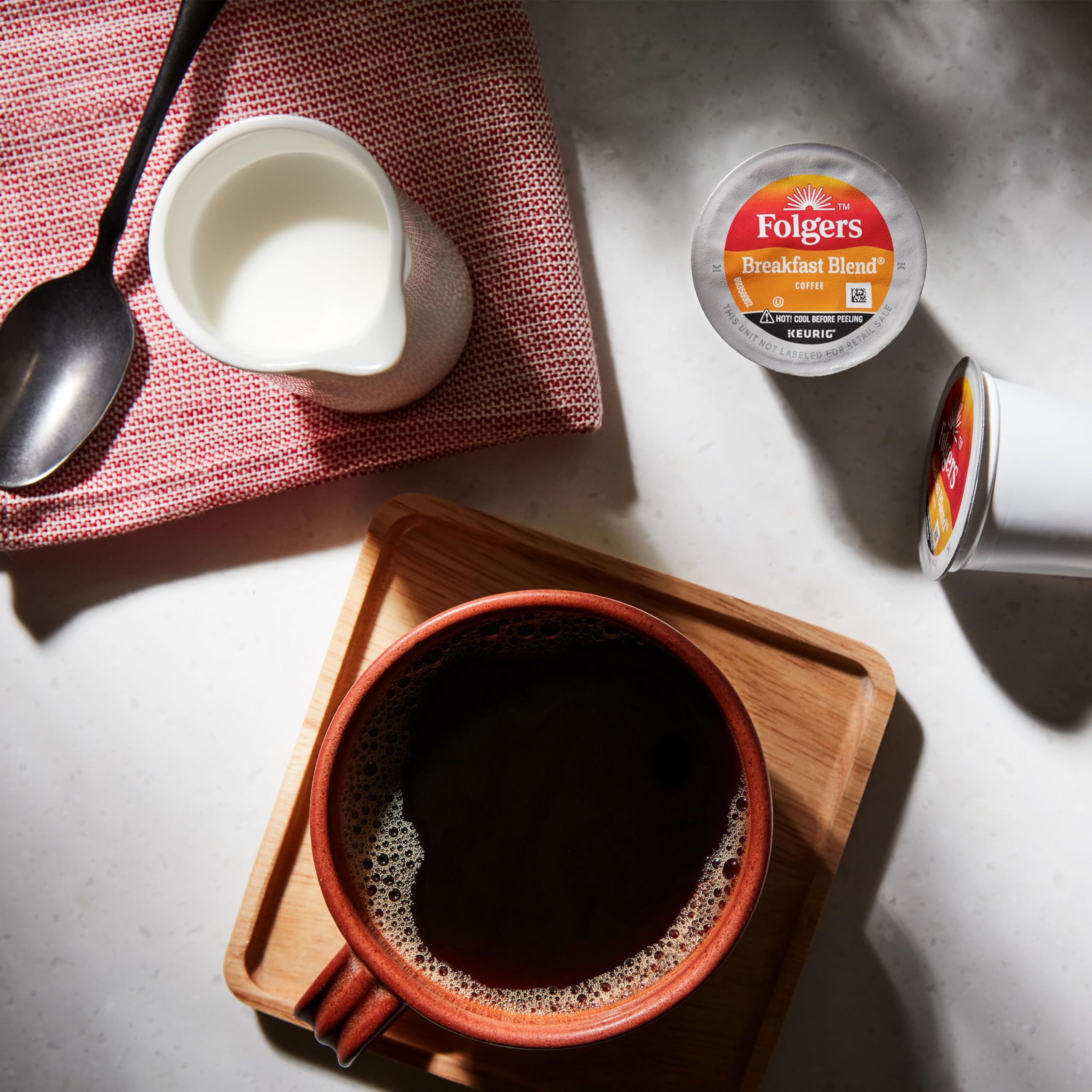 Close-up of Folgers K-Cup pod top sealing freshness and easy use