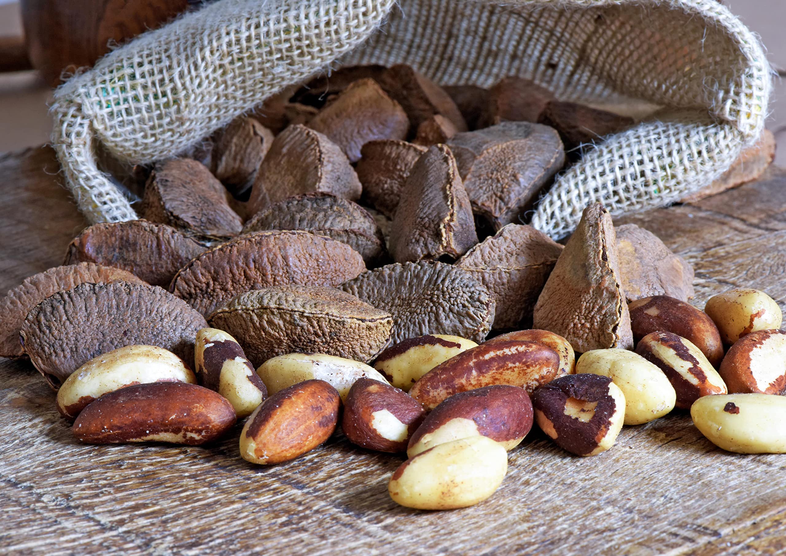 Food to Live hand holding a nut for scale demonstrating portion size guidance