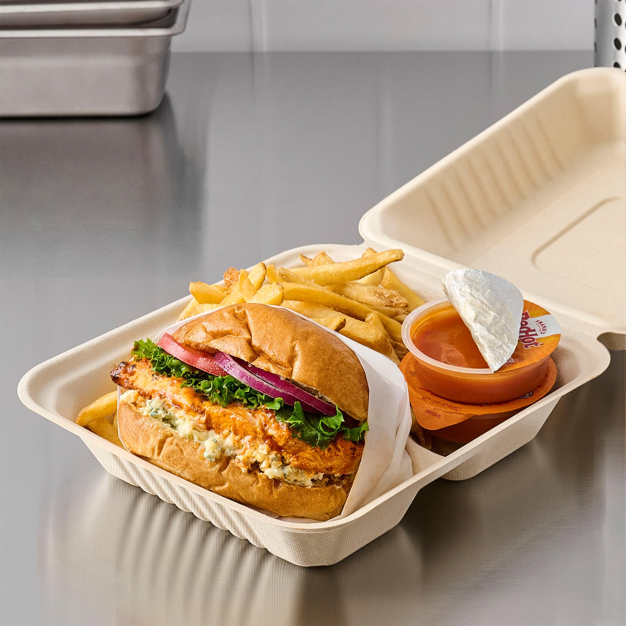 Frank's RedHot stacked case boxes showing bulk storage and cost savings