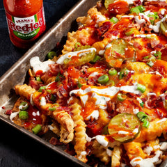 Frank's RedHot pouring over wings to add tangy dill pickle flavor boost