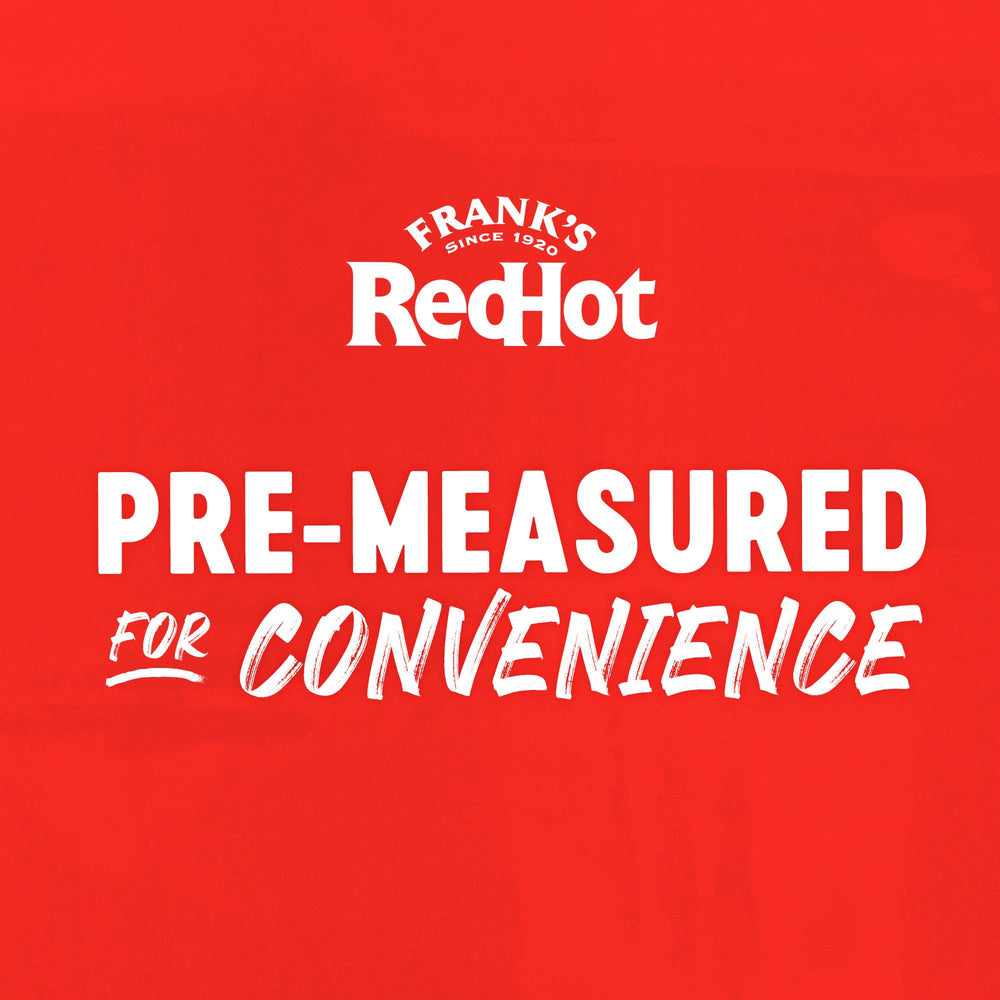 Frank's RedHot cup in hand for scale showing one-serve convenience