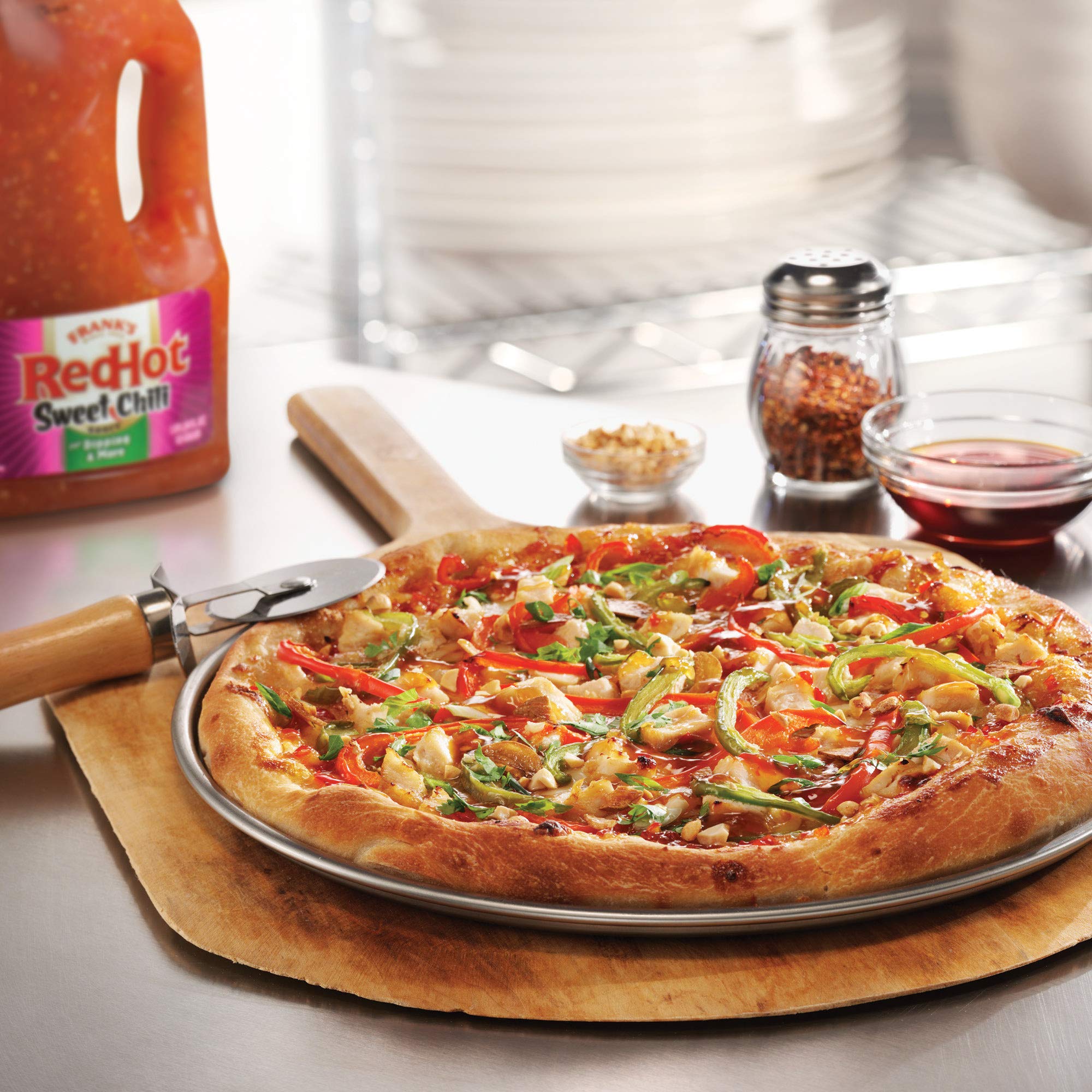 Frank's RedHot half-gallon next to a bottle showing bulk volume savings