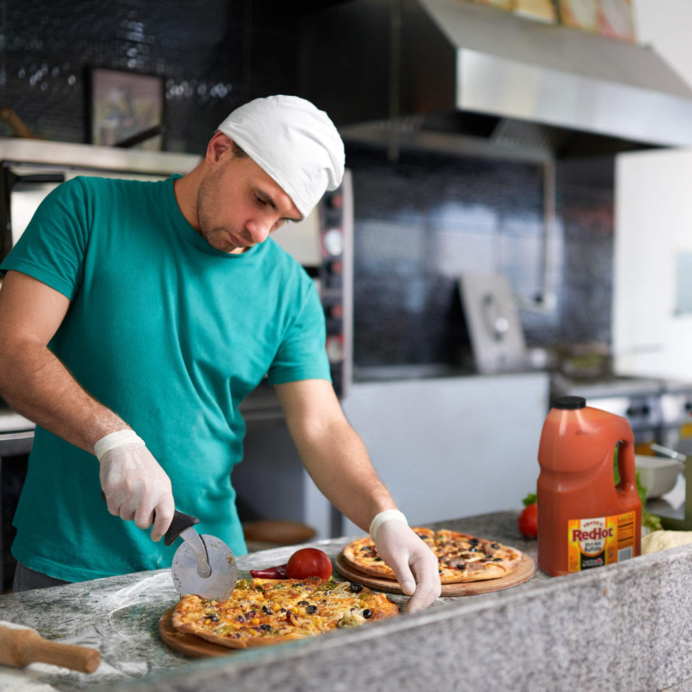 Chicken wings tossed in Frank's RedHot demonstrating bold flavor and crowd appeal