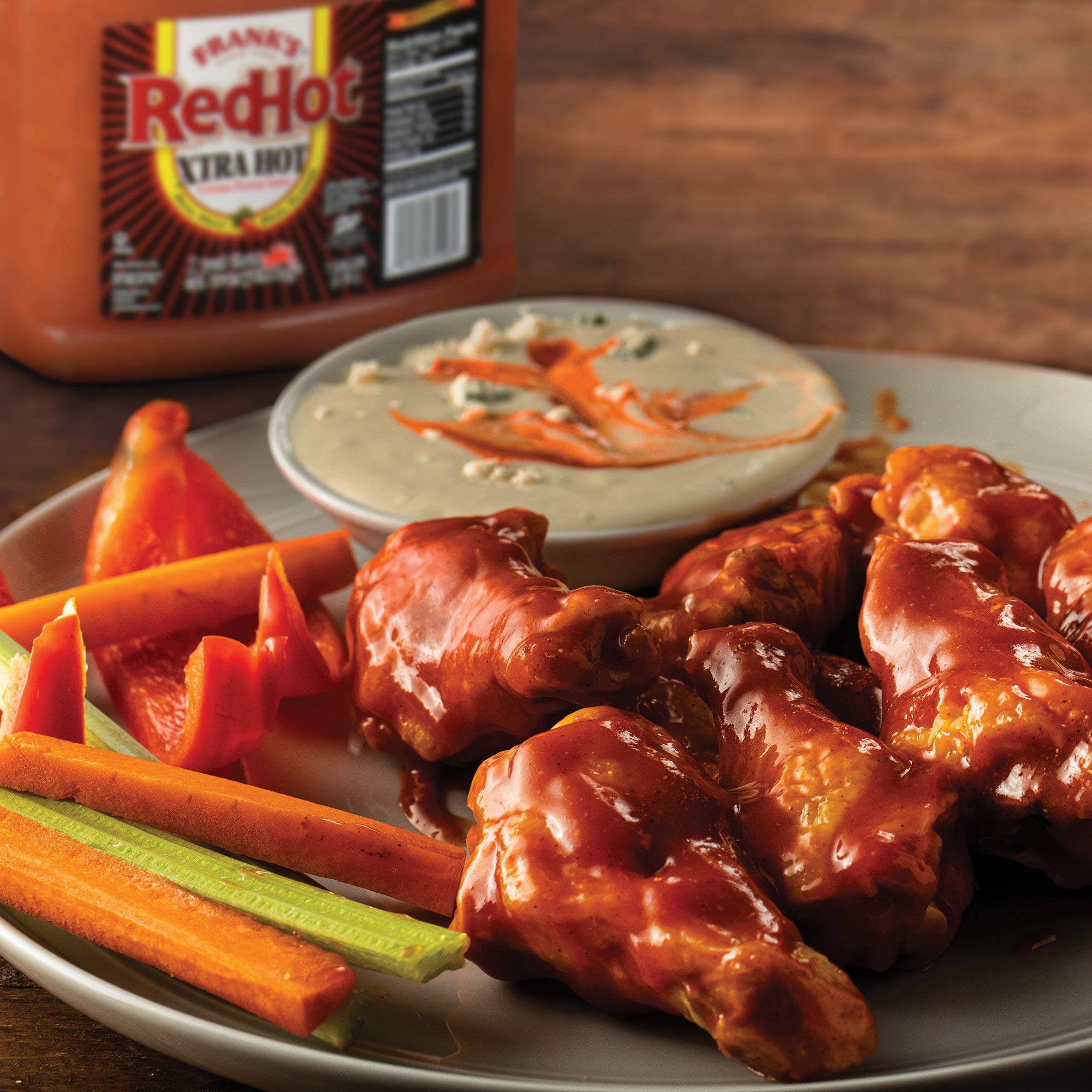 Frank's sauce in dipping bowl beside fries offering spicy finishing touch