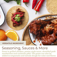 Spoonful of Fresh & Wild achiote paste on wooden board ready to season dishes