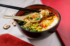 Fresh Finest being sprinkled on soup to enhance umami and deepen broth flavor quickly