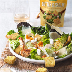 Fresh Gourmet croutons sprinkled on a green salad, adding crunch and savory garlic flavor