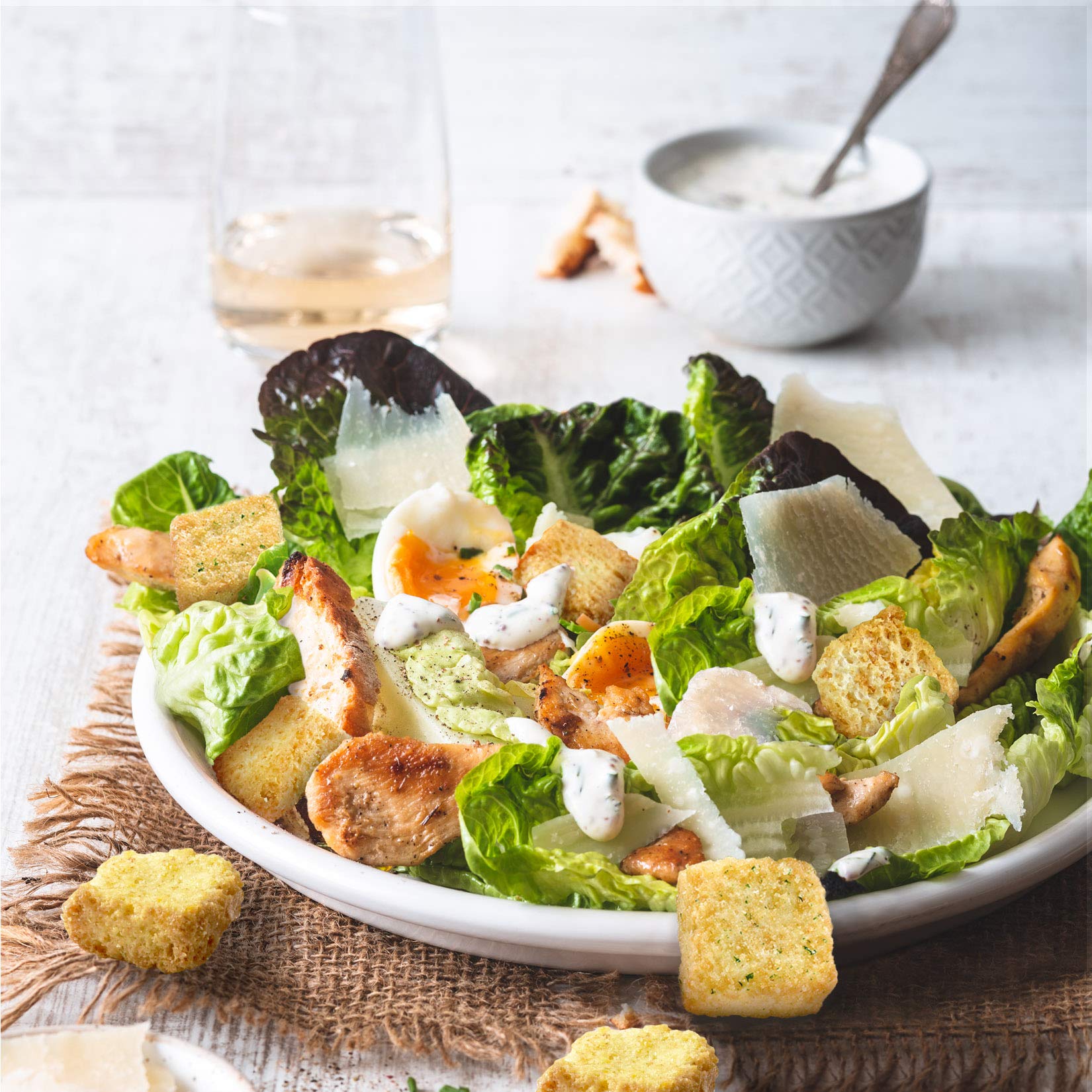 Fresh Gourmet croutons next to a spoon for scale illustrating portion size and crisp topping convenience