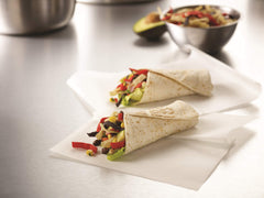 Fresh Gourmet tortilla strips topping a colorful salad for crunch