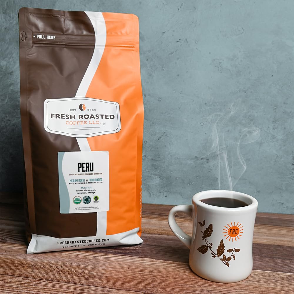 Fresh Roasted Coffee beans in scoop illustrating bean size and uniformity for consistent grind