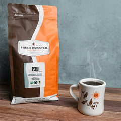 Fresh Roasted Coffee beans in scoop illustrating bean size and uniformity for consistent grind