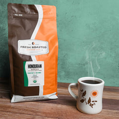 Fresh Roasted Coffee beans in a metal scoop measuring portion for brewing consistency