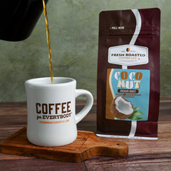 Fresh Roasted Coffee poured into mug illustrating coconut flavor enjoyment