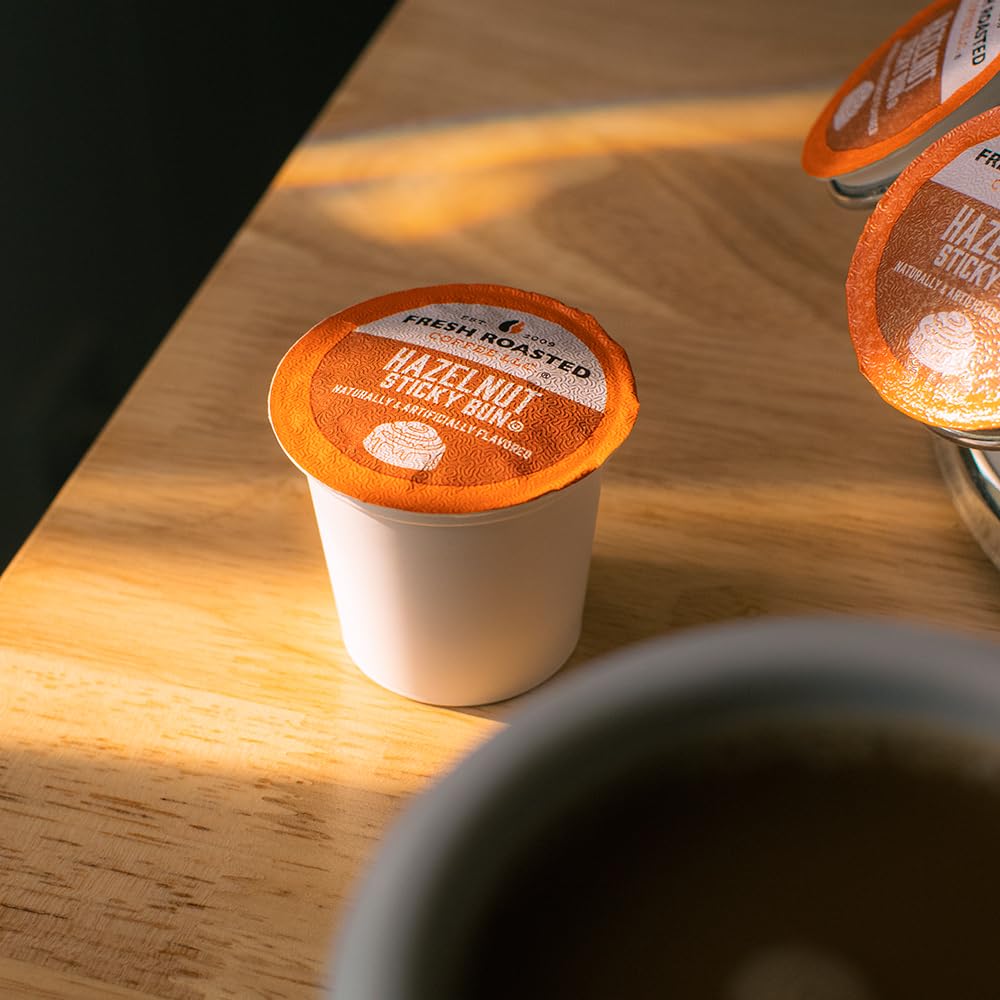 Hand holding a Fresh Roasted Coffee hazelnut K-Cup pod showing scale and convenience