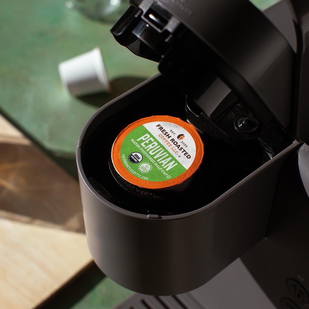 Fresh Roasted Coffee pods in hand for scale and single-serve convenience