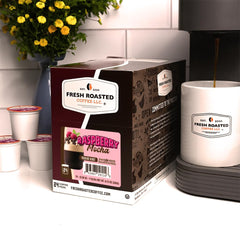 Fresh Roasted Coffee beans and raspberry-chocolate flavor ingredients showing balanced profile