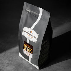 Fresh Roasted Coffee close-up whole beans showing dark roast and glossy oils